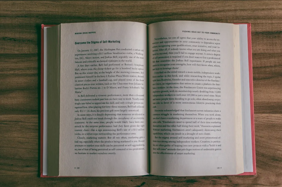 An open book on a wooden table, a quiet place to learn manifestation terms